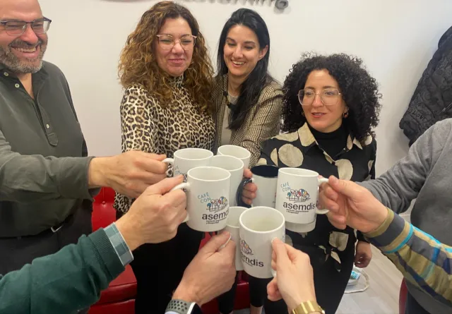 Asistentes al II Encuentro ASEMDIS brindan con tazas del Café con ASEMDIS